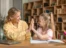 A woman and a little girl sitting at a table as part of home healthcare.