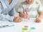 A woman and a child sitting at a table as part of our home healthcare for children aged 3-18.