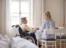 An Americare nurse talking to a woman in a wheelchair as part of home care options.