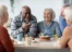 A group of older people sitting around a table.