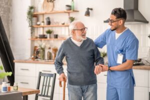 Home Health Aide Assisting an Elderly Man with Walking