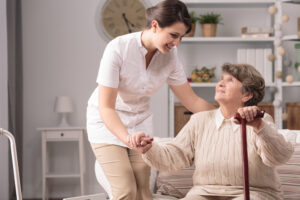 Female Caregiver Helping Elderly Diabetic Patient Test Their Blood