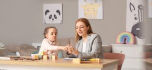 Occupational Therapist Working With Child At Their House