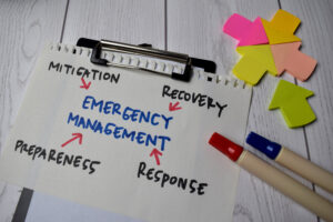 Emergency preparedness plan written on a piece of paper, with two markers on the side, and arrow post-its on the right-hand side.